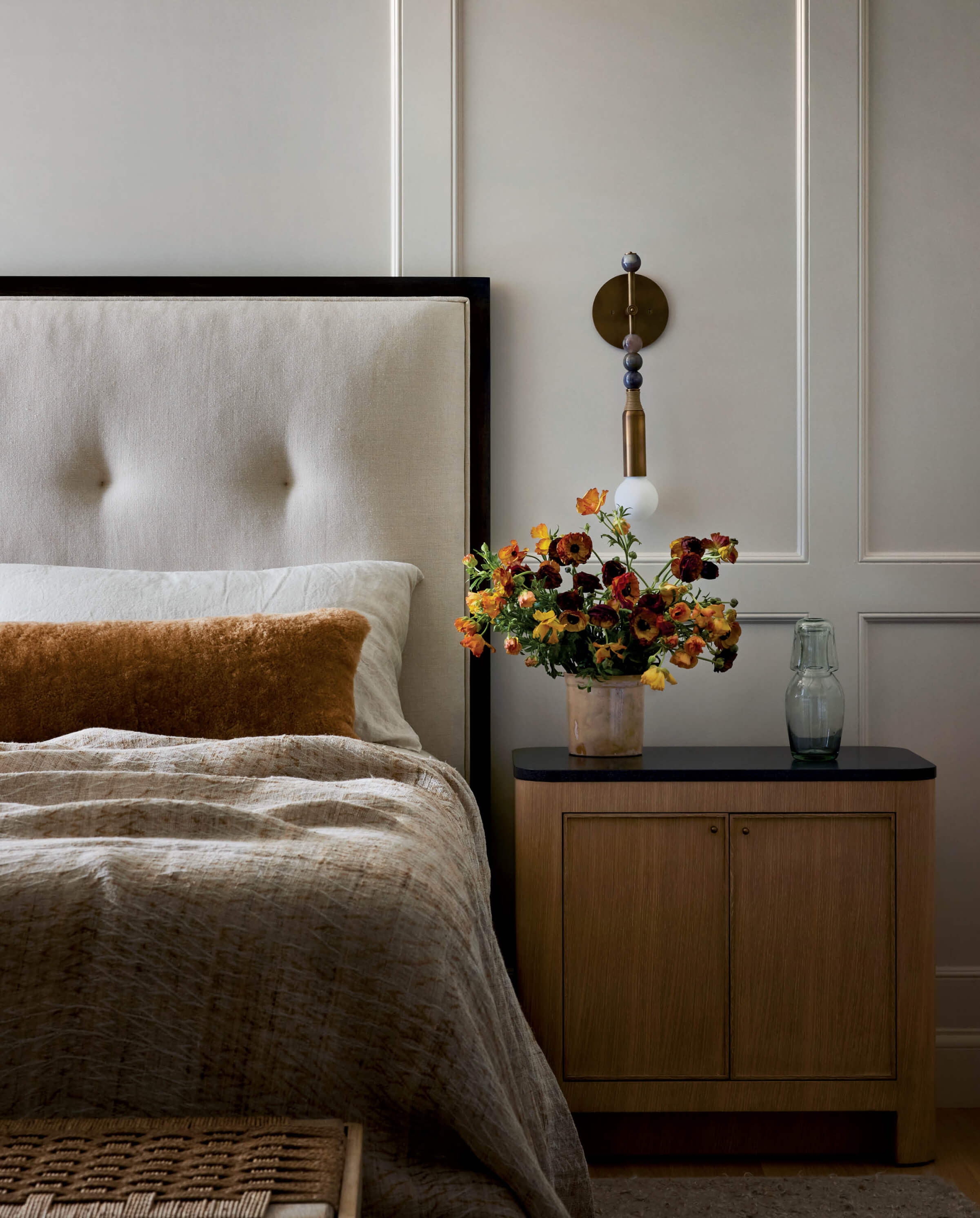 neutral tan cream and brown primary bedroom with nightstand 