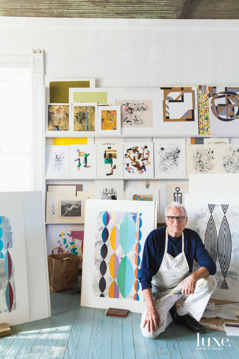 Austin-based artist Helmut Barnett kneels in his studio