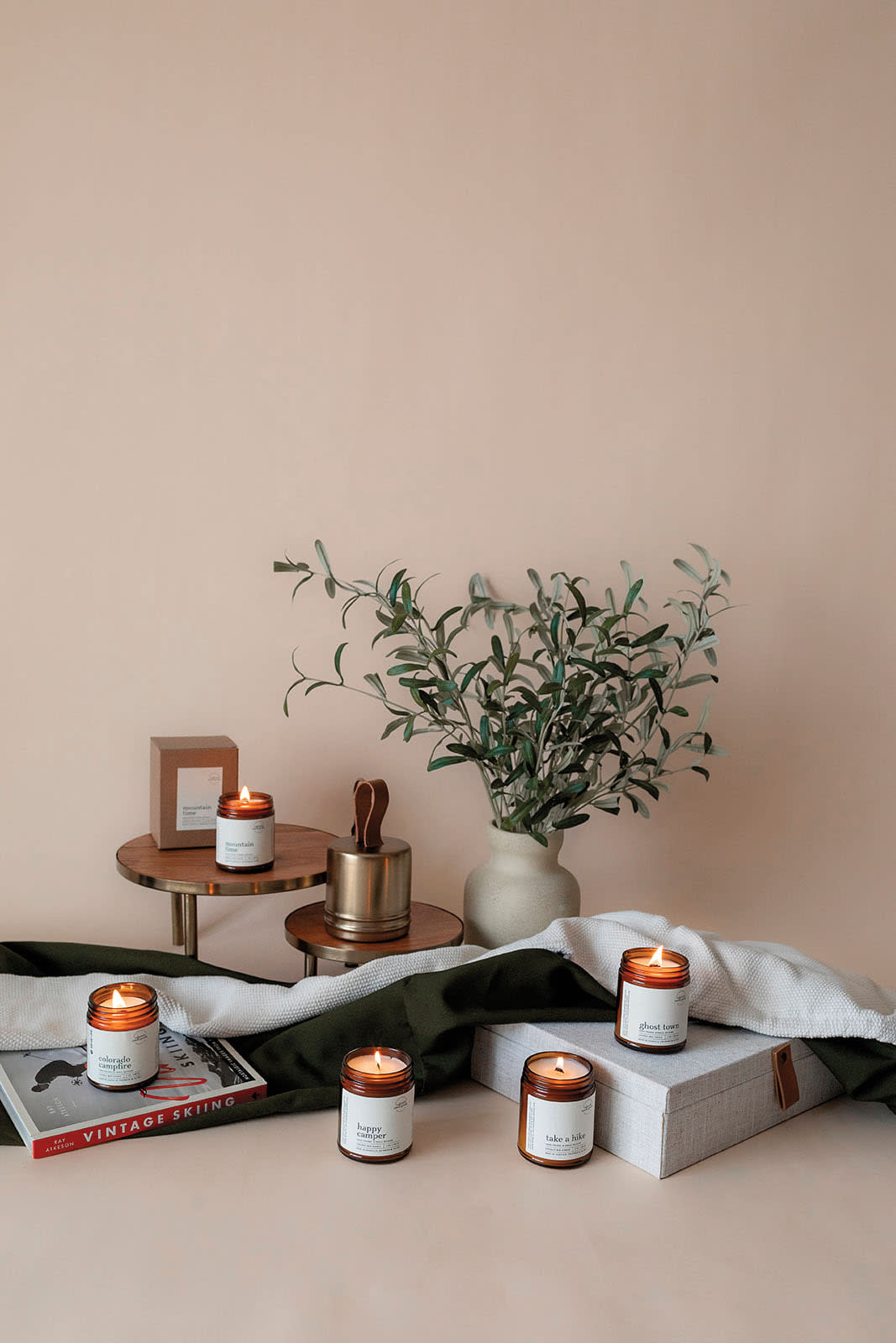 lit candles upon a display from Colorado Smell Goods