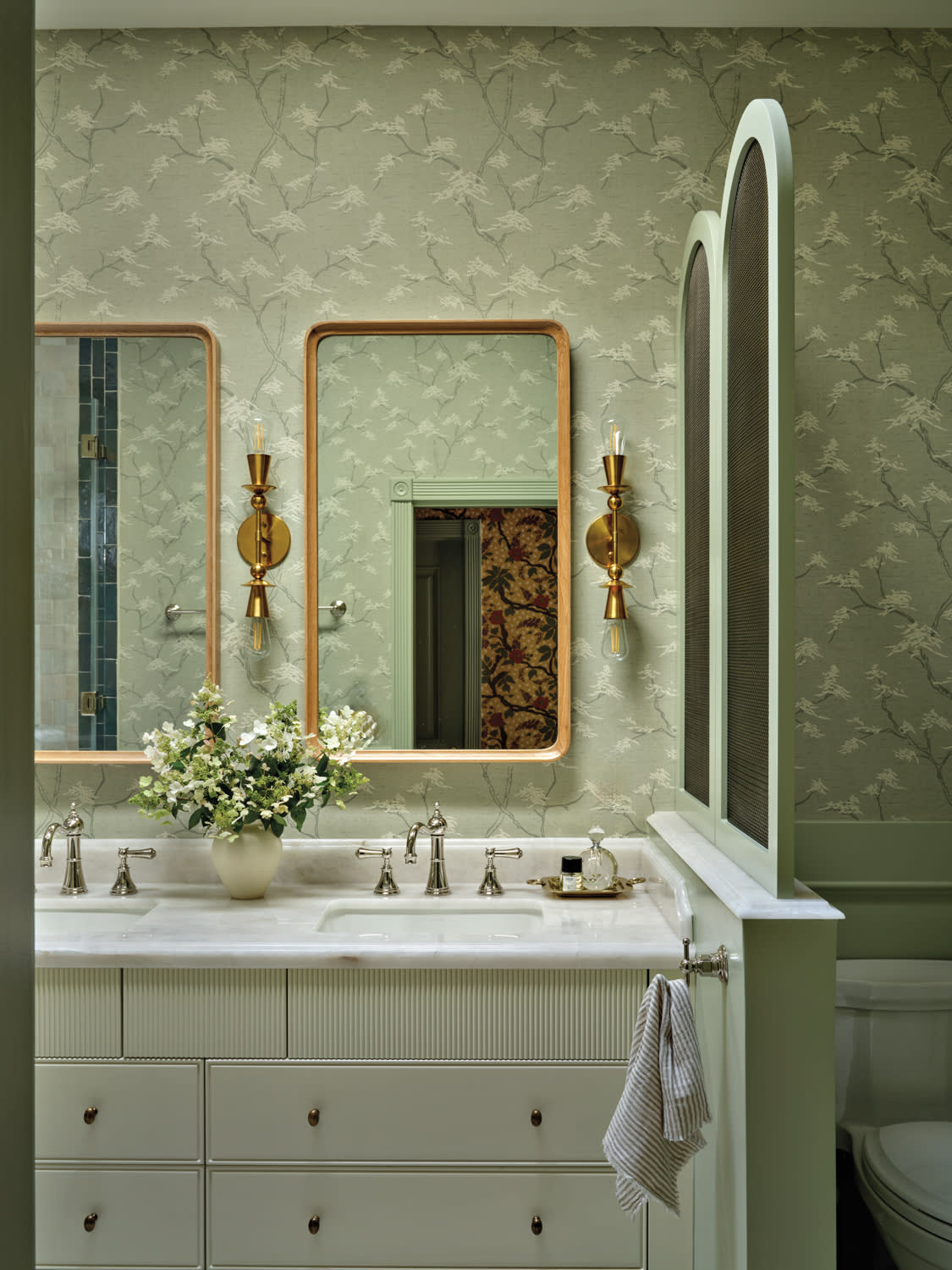 bathroom with green floral wallpaper and a white vanity
