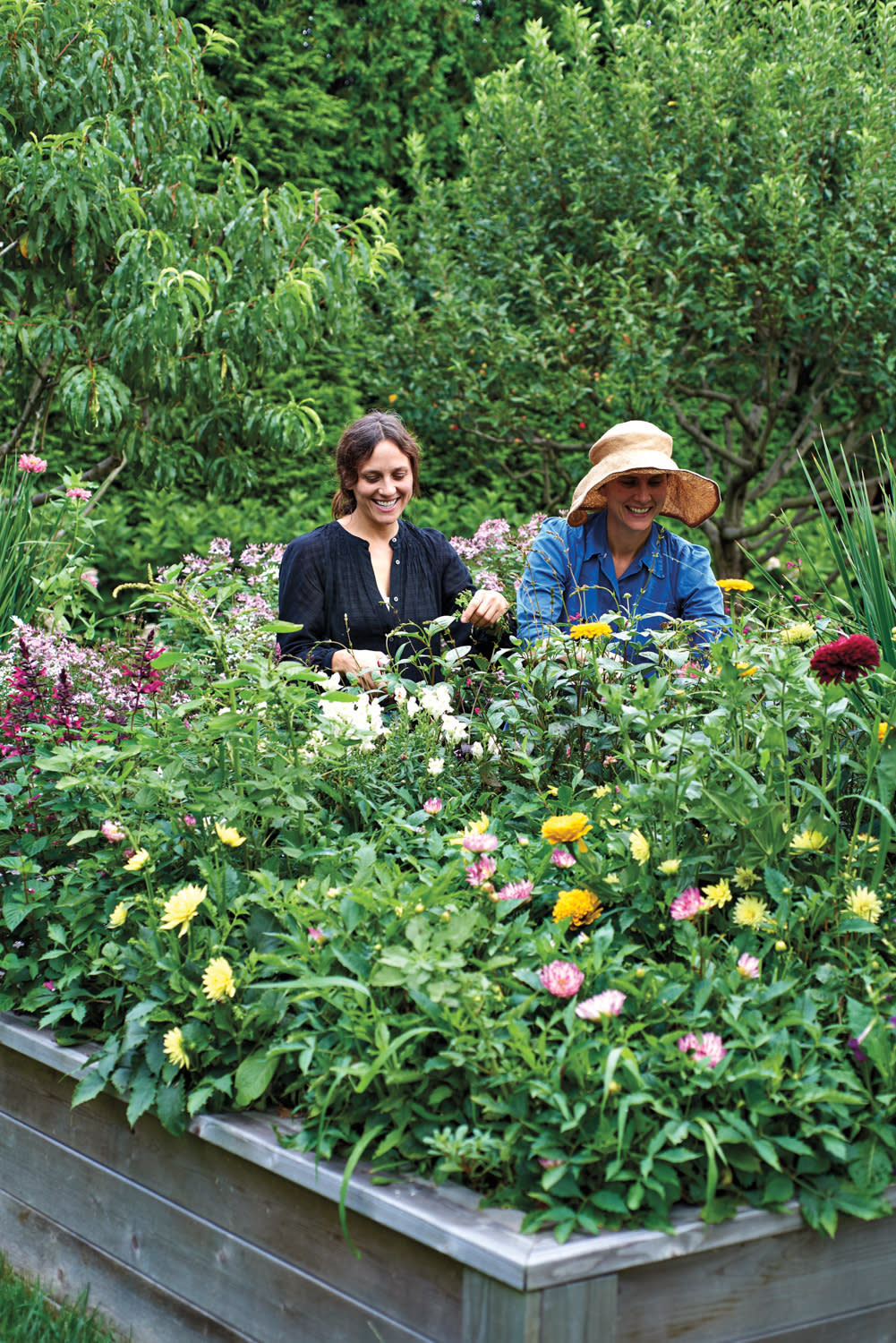 Anna and Emilia deMauro working in a garden