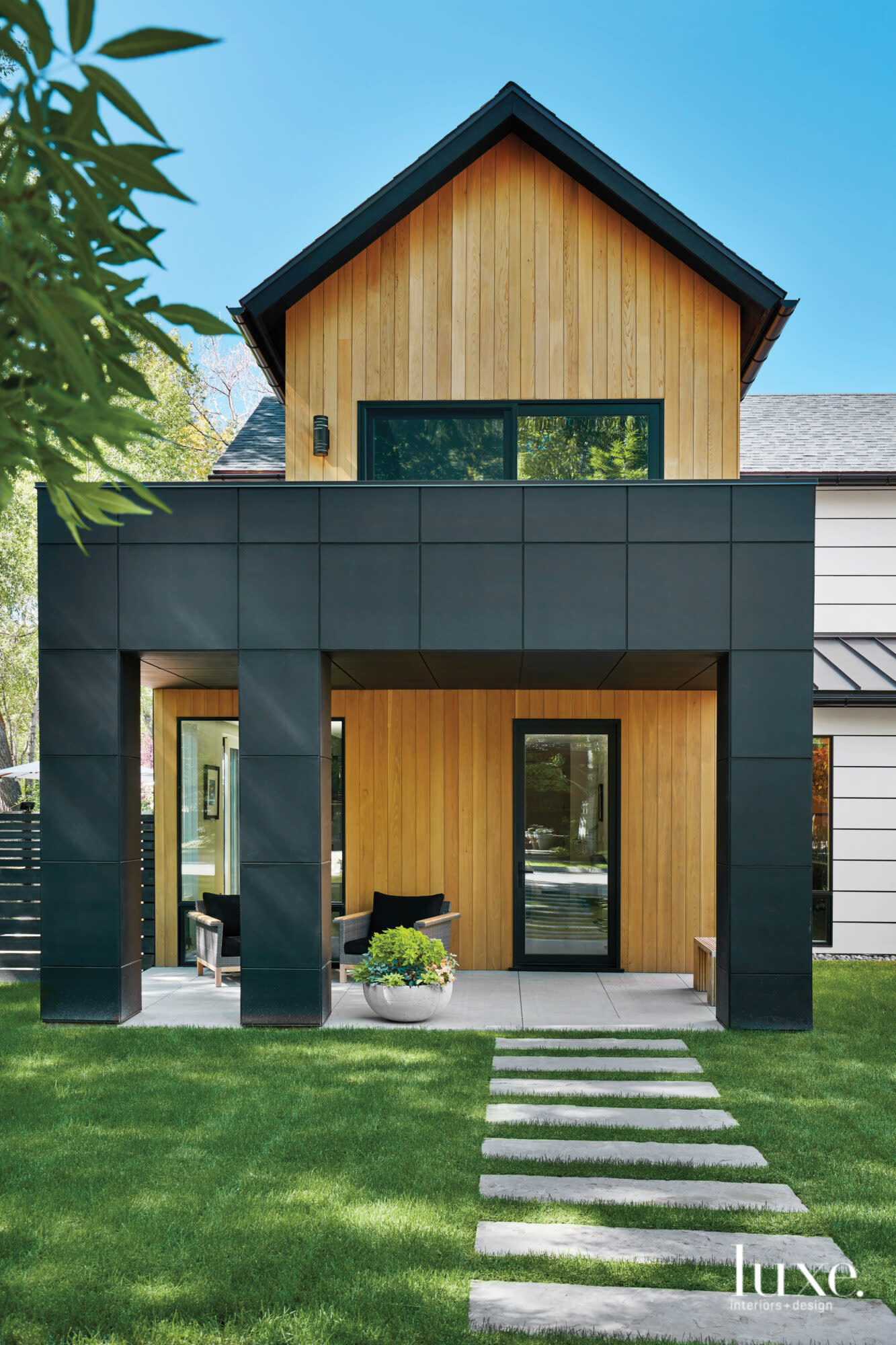 The exterior of a Colorado home features a black overhang and natural cedar siding.