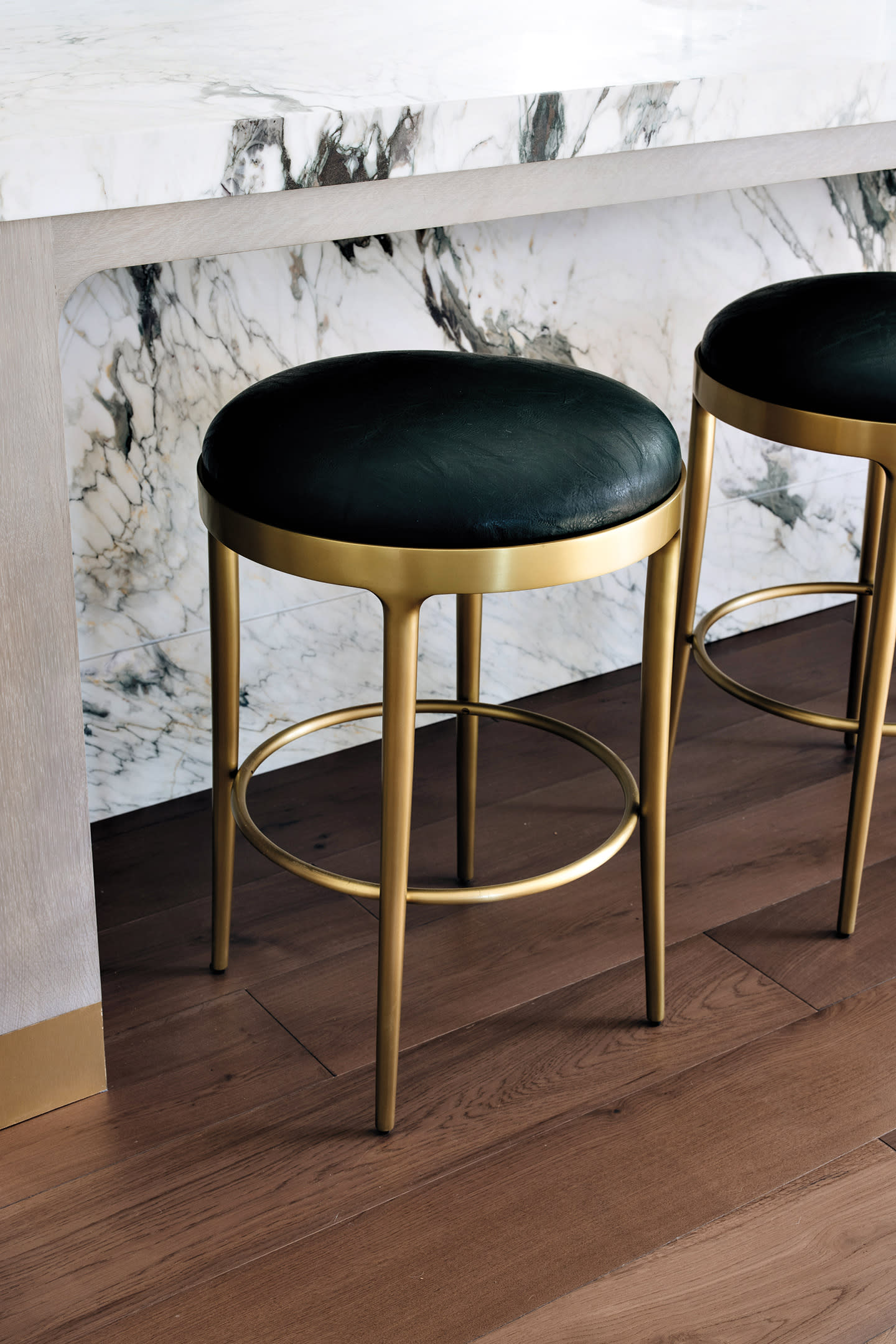 Maximalist counter stools by Baker-McGuire line a kitchen island