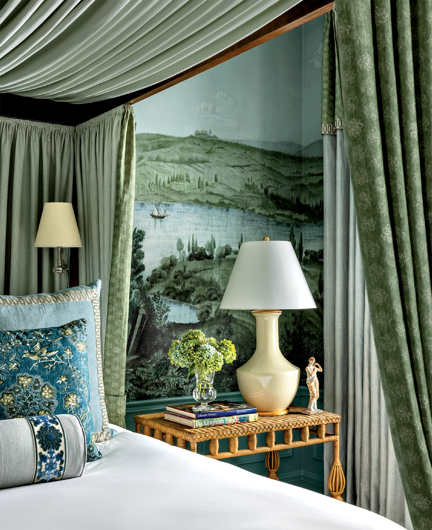 classic bedroom with a Iksel mural on the walls and green fabrics canopying the bed