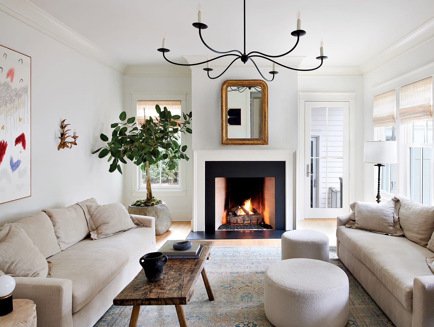 traditional white living room with a black fireplace