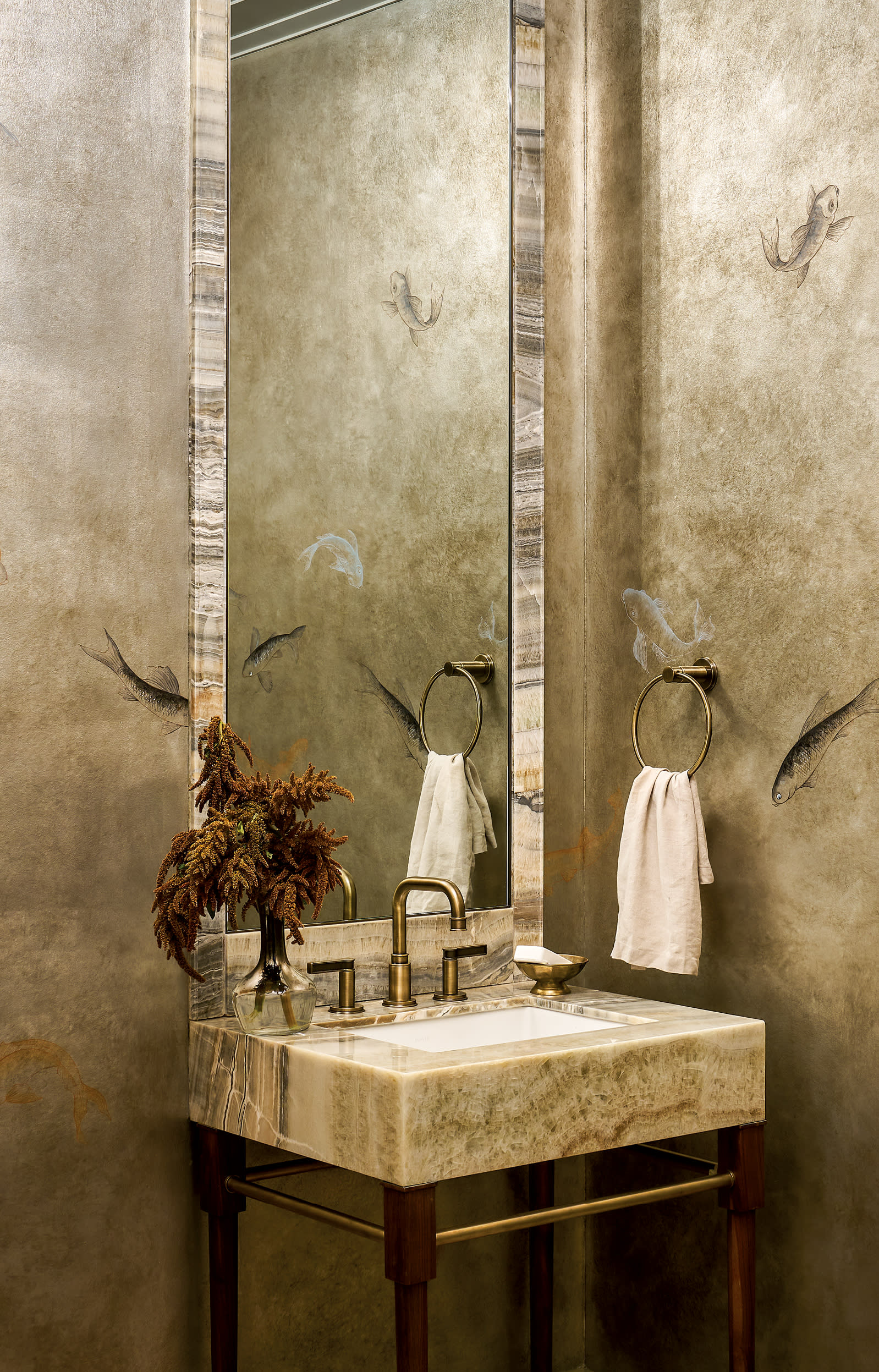 a koi fish mural in golden tones wrap this modern powder room