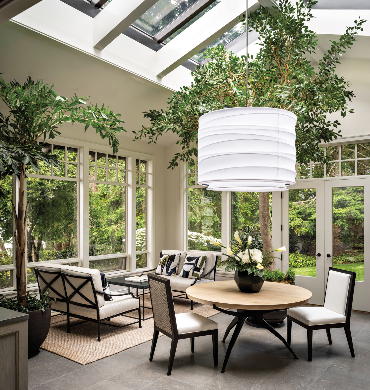 A sunroom has a large light fixture and is inspired by the Whidbey Island landscape.