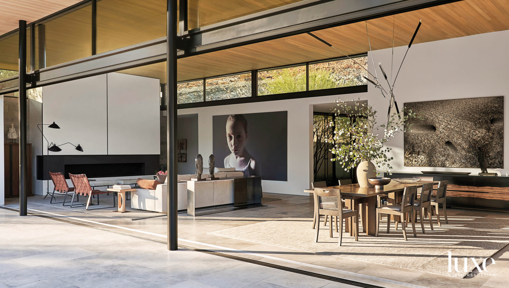 Shot of great room with dining area and large artworks on walls behind