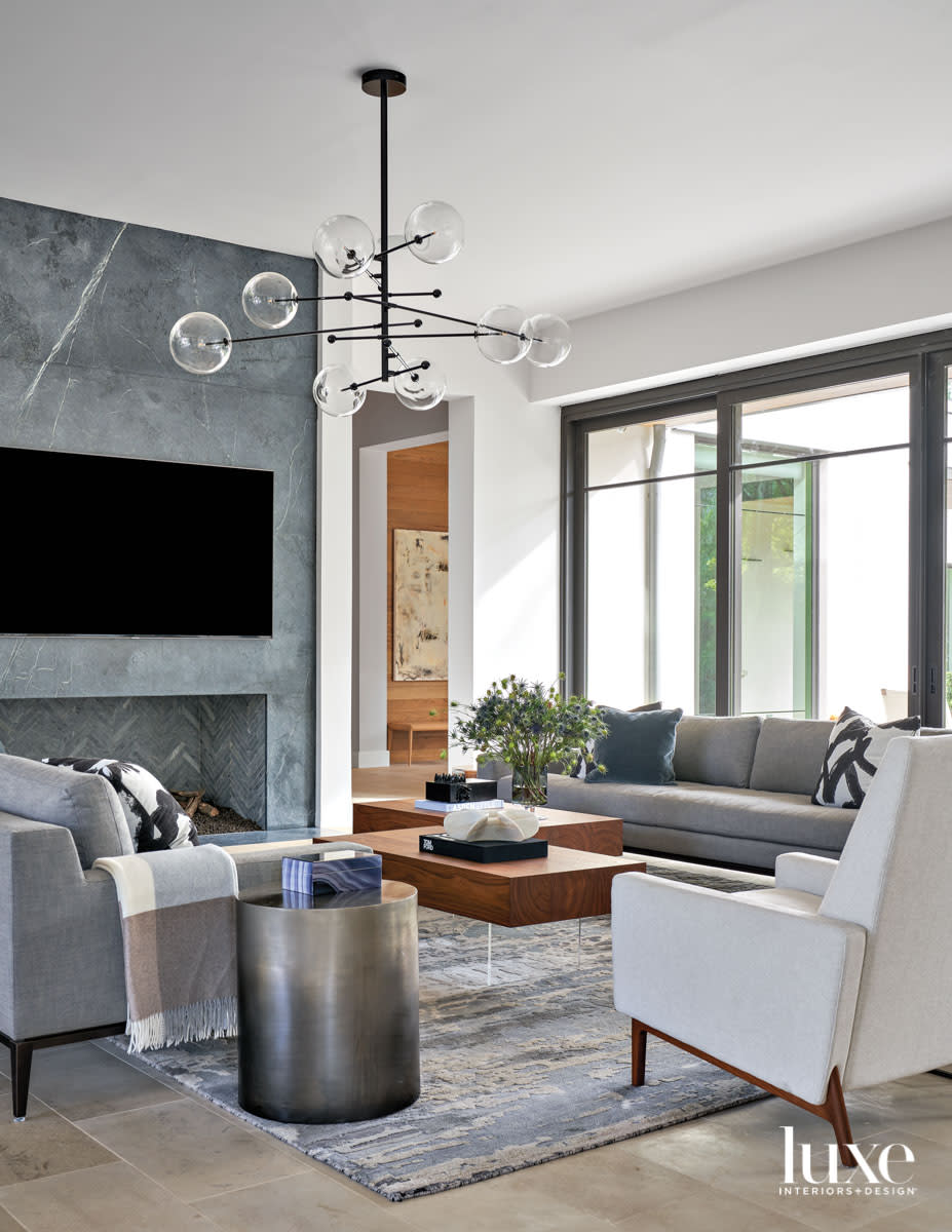 gray and white living room with soapstone fireplace