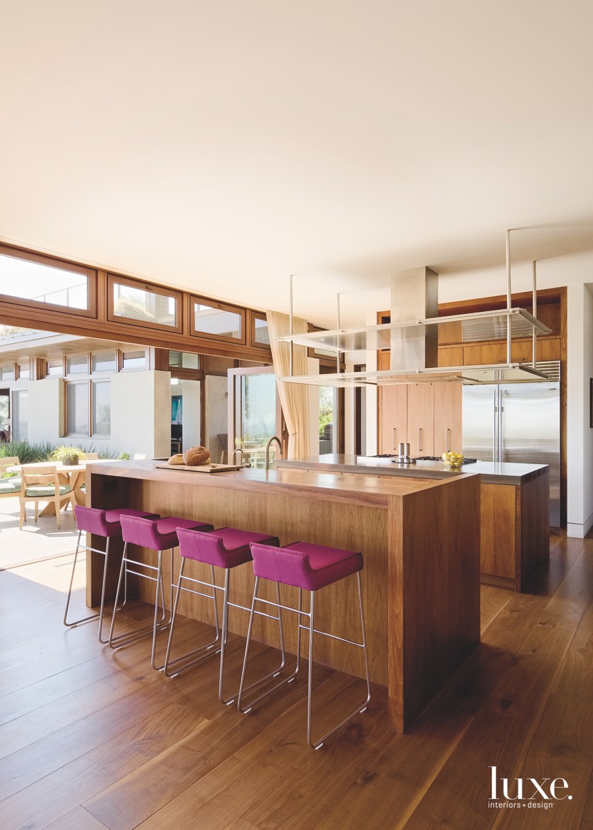 wood kitchen with two islands and chrome counter stools