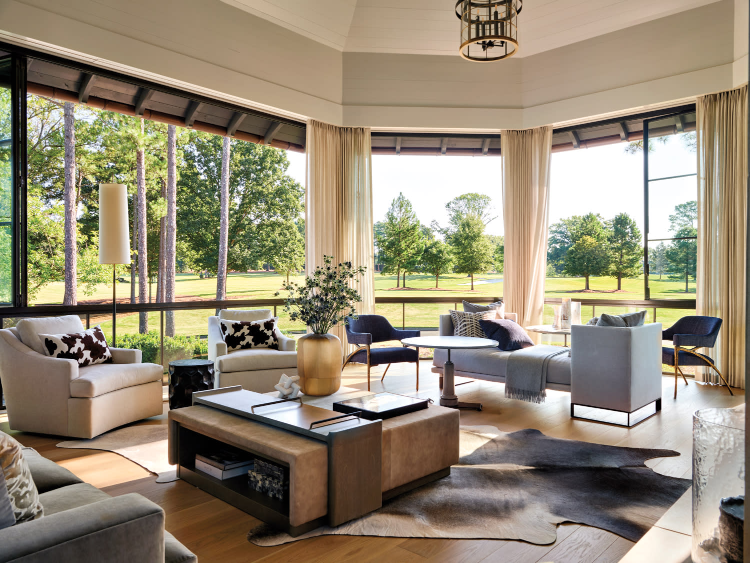 Sun room with multiple conversation groups overlooking a golf course