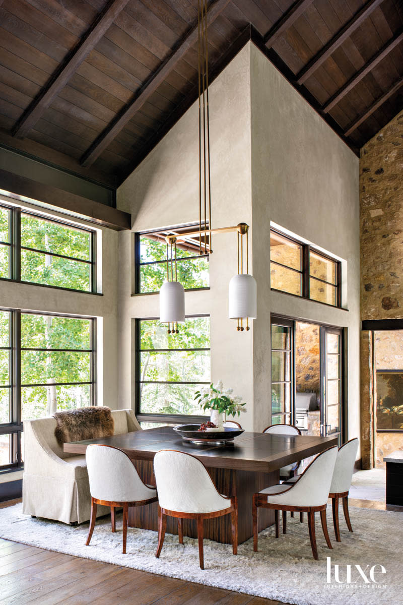 A dining room has large banks of windows.