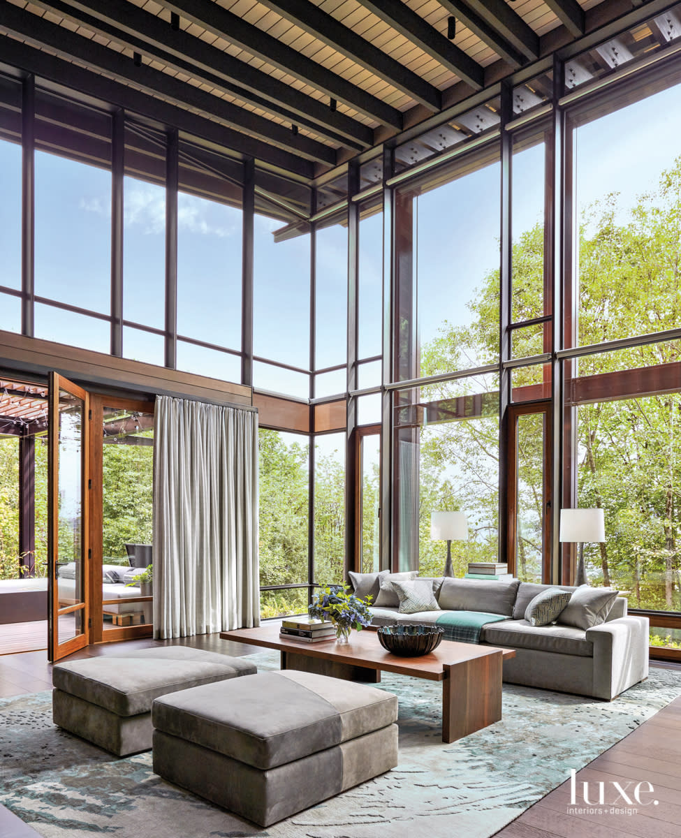 living room with high window ceilings and couch and two seats