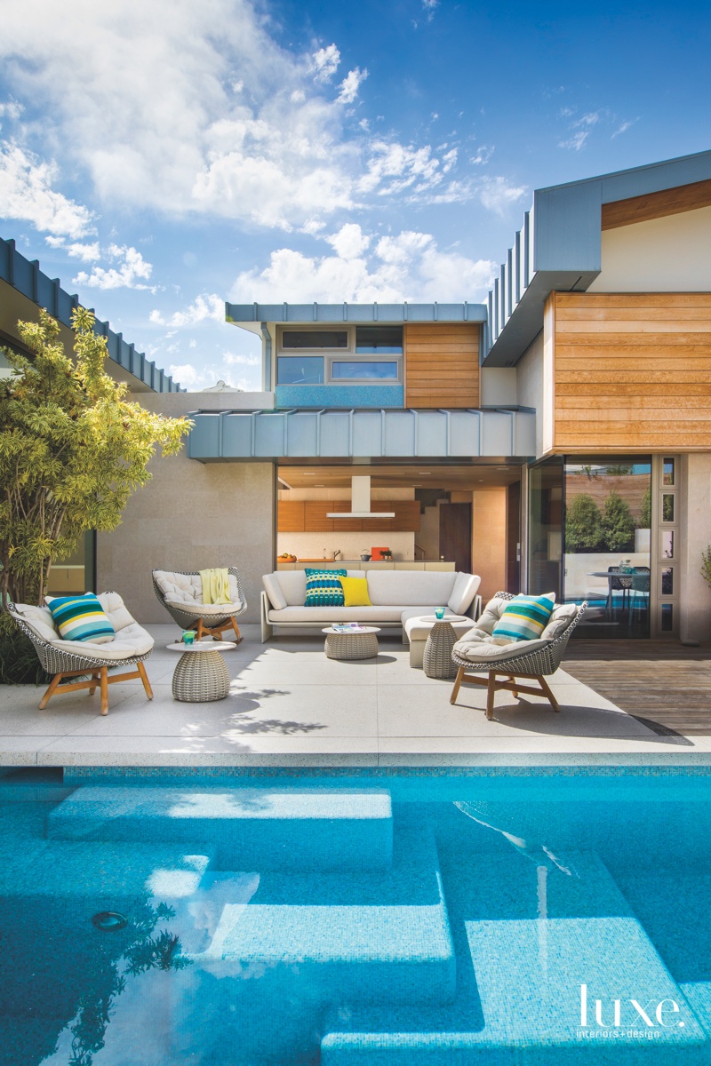 contemporary exterior neutral pool sitting area blue yellow accents