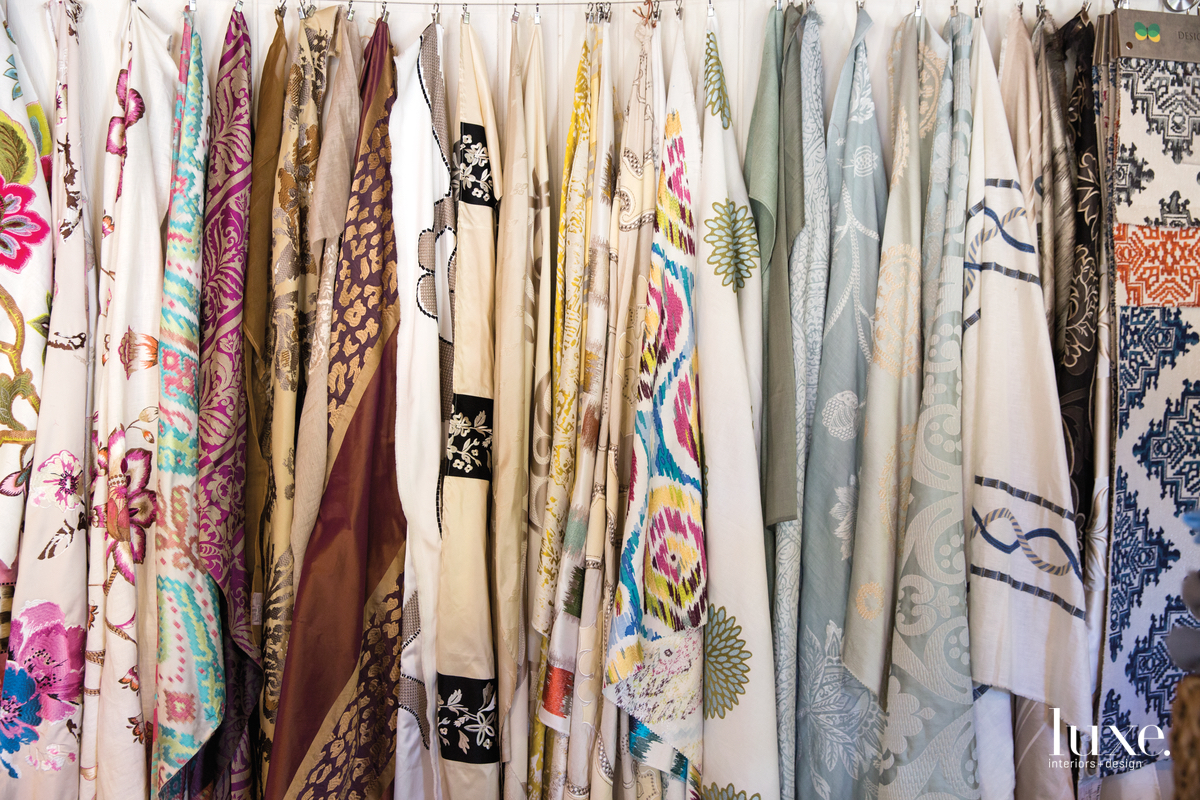 The designer started by importing and then embellishing pashminas, but today she oversees the creation of fabrics, some of which are displayed on the walls of her studio.