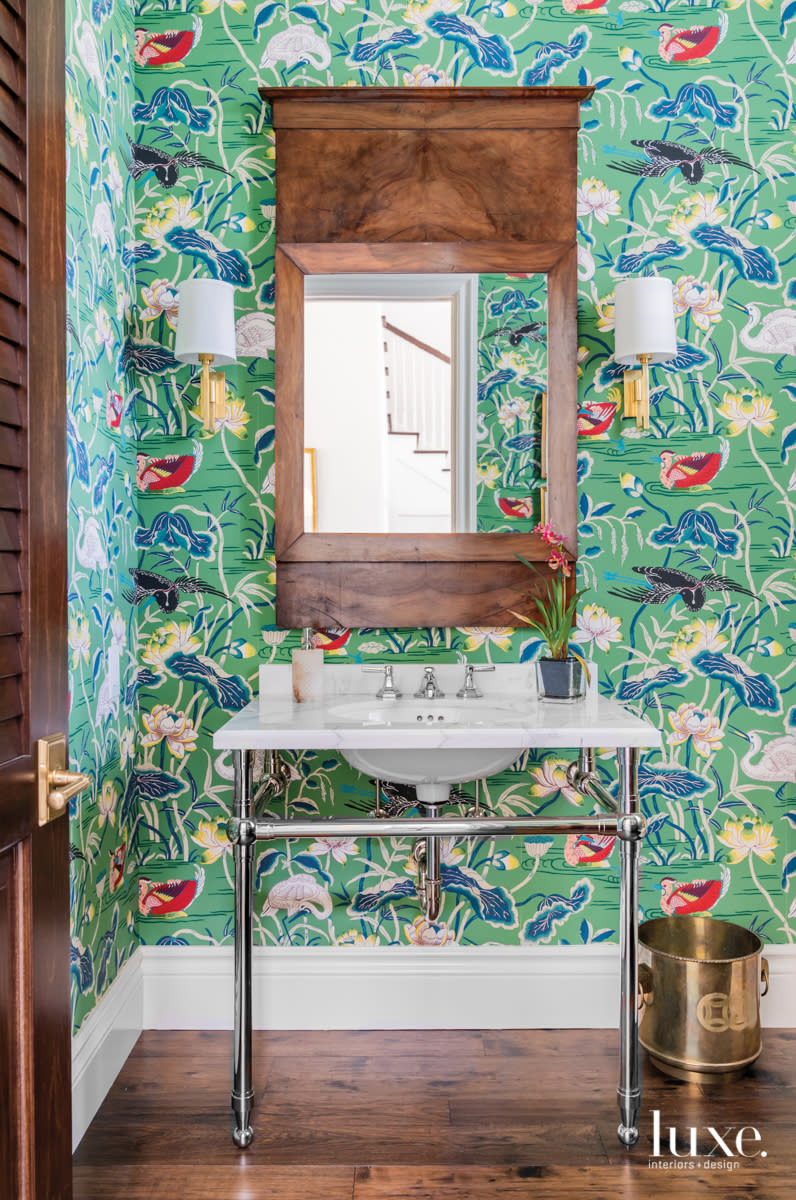 bathroom with lotus garden wallcovering and a nickel vanity console with marble top