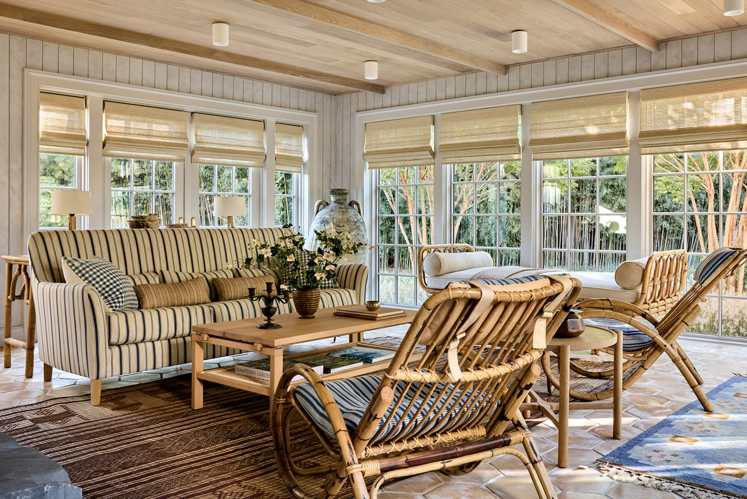 sun room with striped sofa, rattan lounge chairs, oak ceiling, and floor-to-ceiling windows