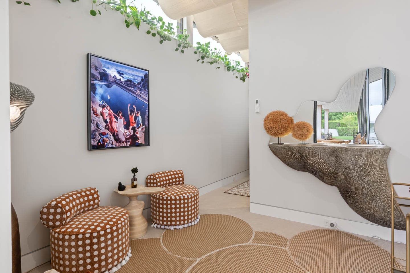 modern cabana lounge with tasseled ottomans and circular carpets