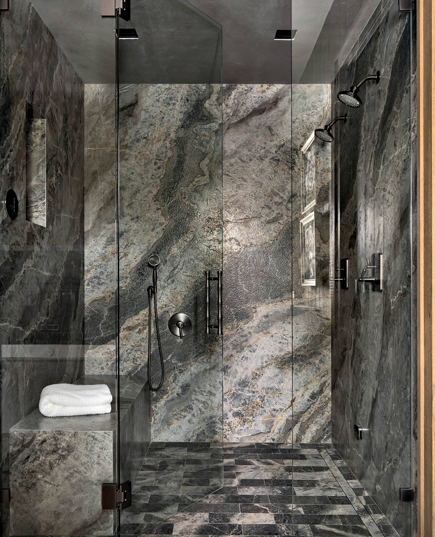 primary bathroom with dramatically veined gray quartzite on the shower walls