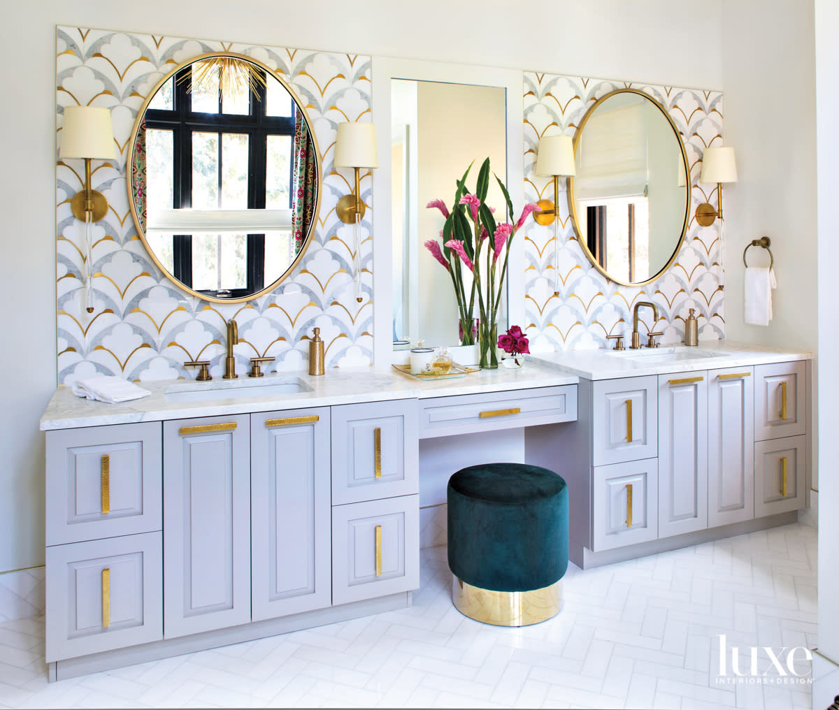 glam primary bathroom with brass sconces colorful backsplash tile