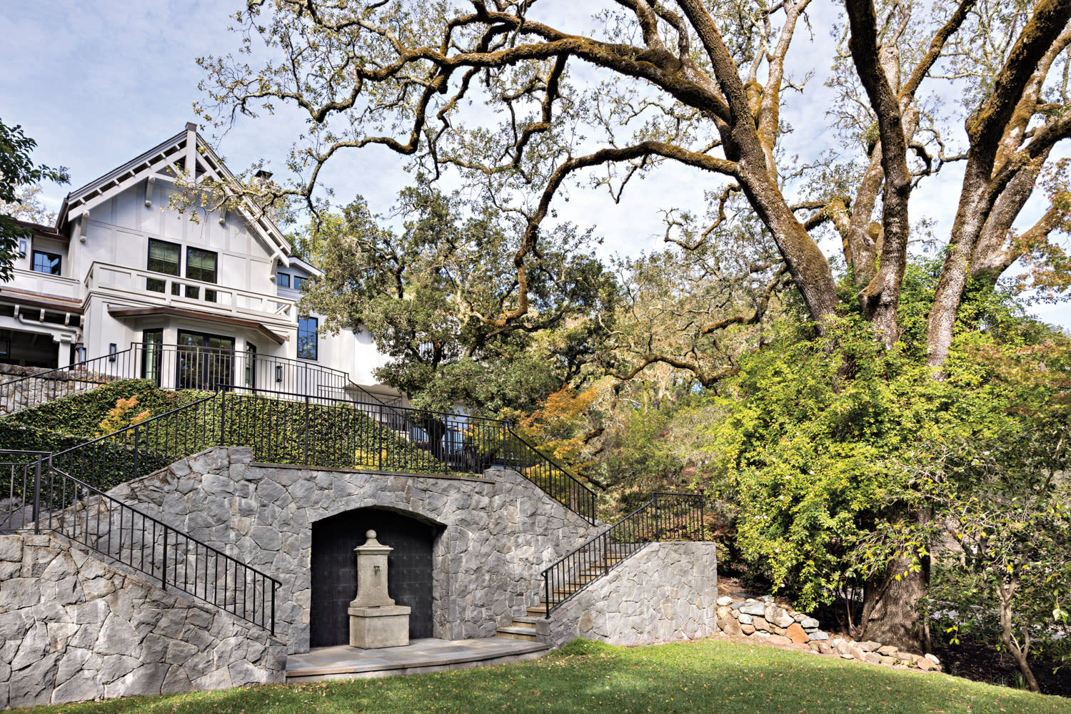 A stone staircase leads up to this 1906 Tudor home's entry by Melissa Warner Rothblum