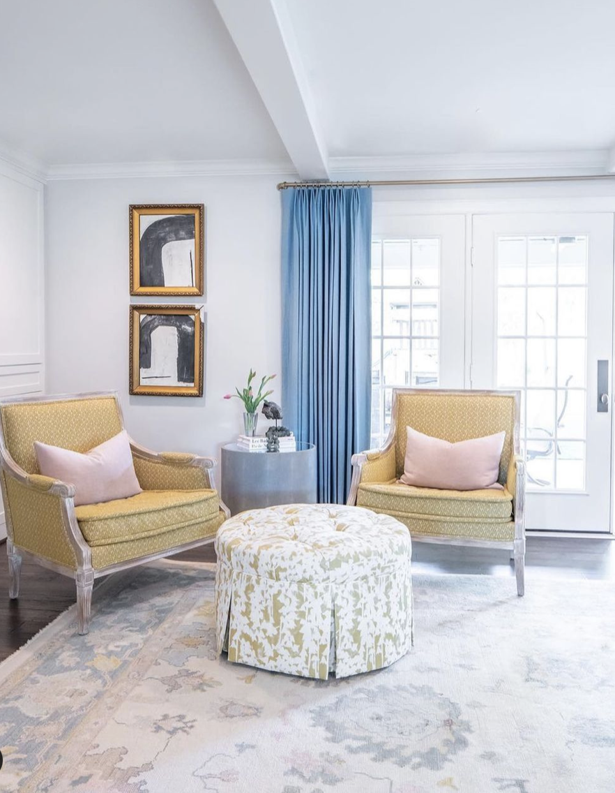 A sitting area featuring a white with blue and pink rug.