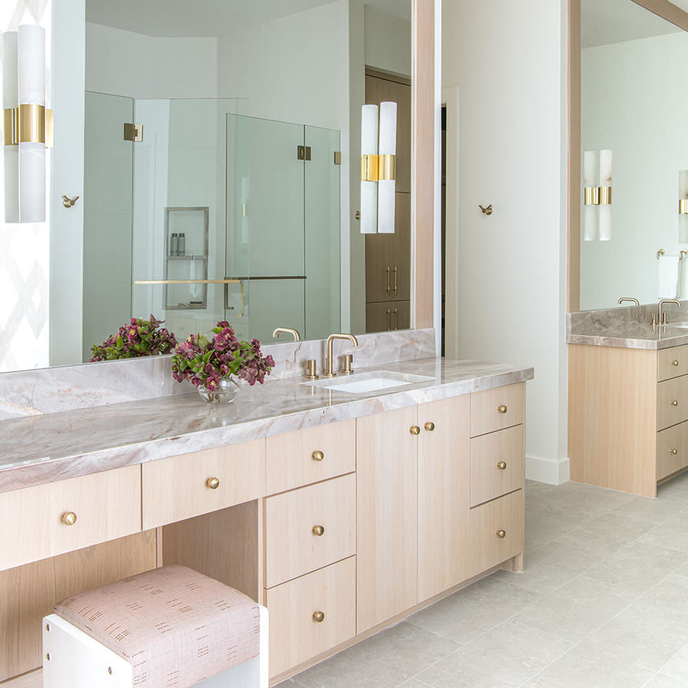 This primary bathroom is a vision of rosy elegance, with shades of blush and pink flowing through the marble countertops, cabinetry, and soft furnishings. Brushed brass hardware adds a touch of sophistication, while the harmonious palette creates a sereneand charming atmosphere. Photography by Strictly Natural Light.