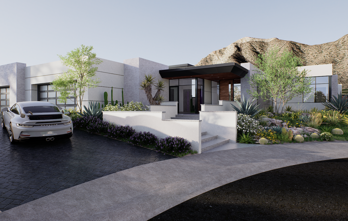 Modern desert-modern home entryway with a bold black overhang and glass front door, framed by sleek white-stucco volumes. A curved paver drive with a silver sports car leads past layered xeriscape beds of agave, yucca, flowering shrubs, and barrel cacti toward rugged sun-lit mountains in the background.