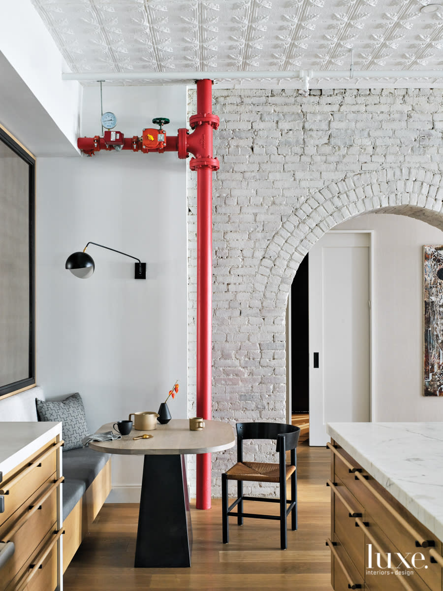 breakfast nook with red pipe down to the floor