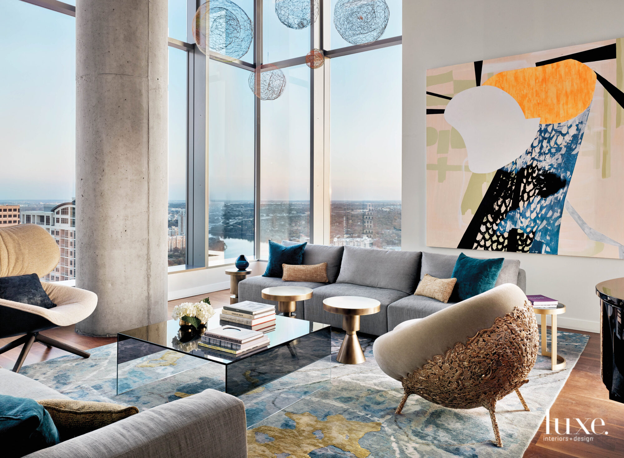 Living room of a high-rise featuring sculptural furnishings and showcasing a collection of art.