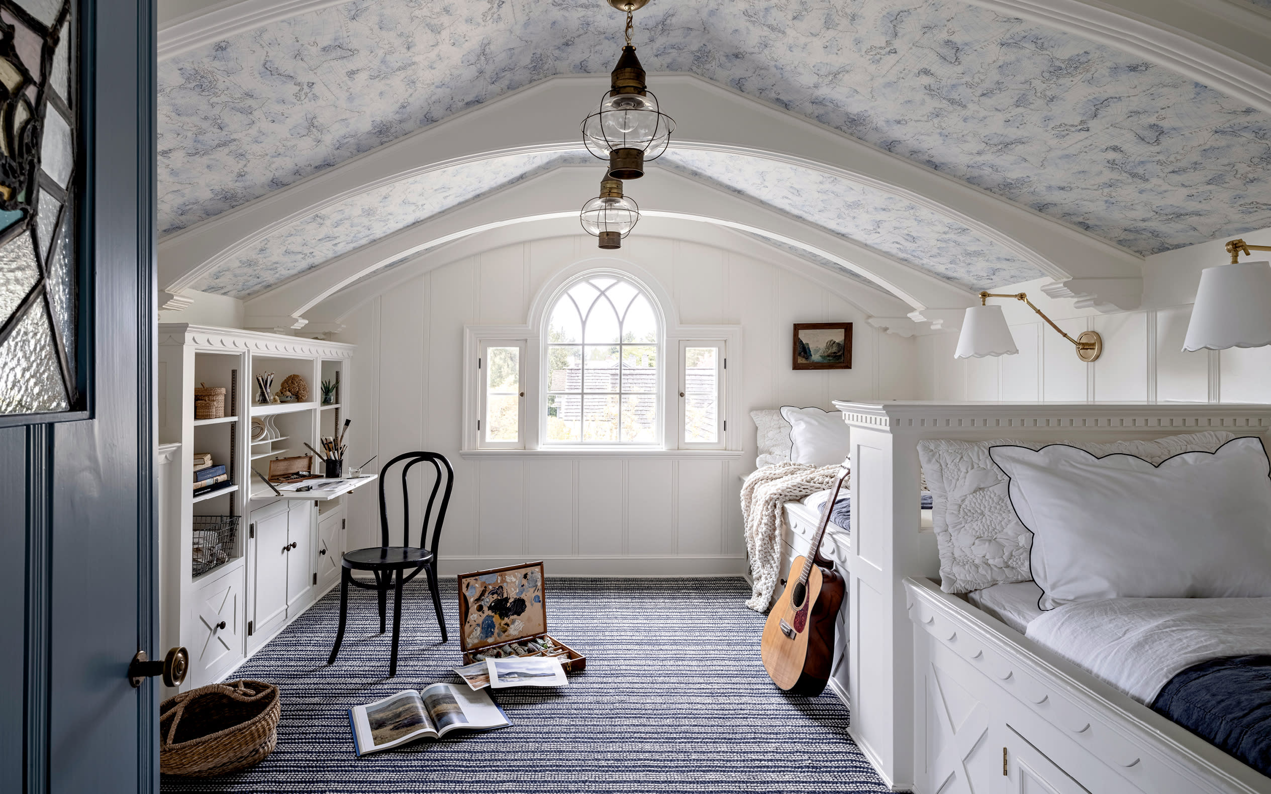 whimsical white and blue room with matching twin beds