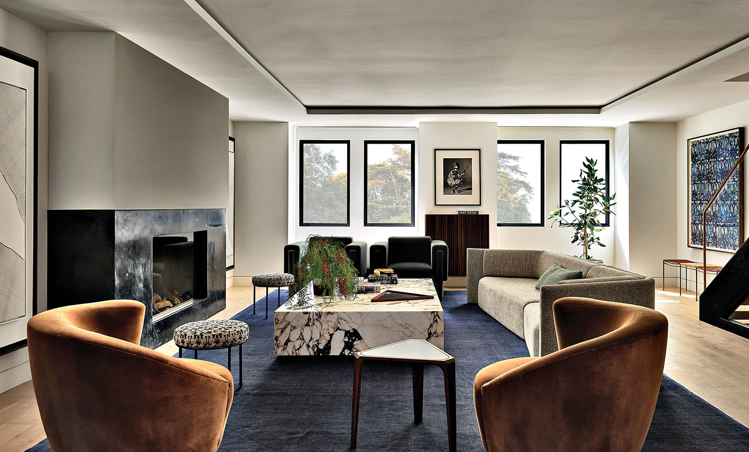modern living room of a San Francisco home with curving orange swivel chairs 
