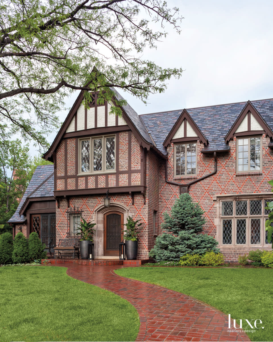 The exterior of this Tudor home in Denver is composed of red brick and wood timbers.