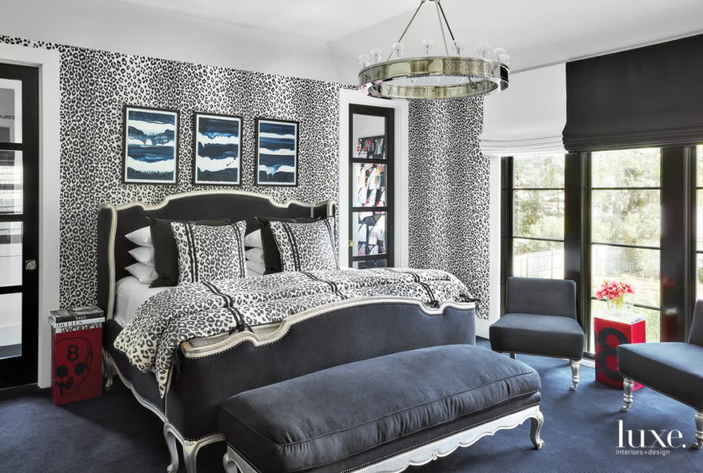 master bedroom with navy leopard schumacher wallcovering and silver-leaf bed