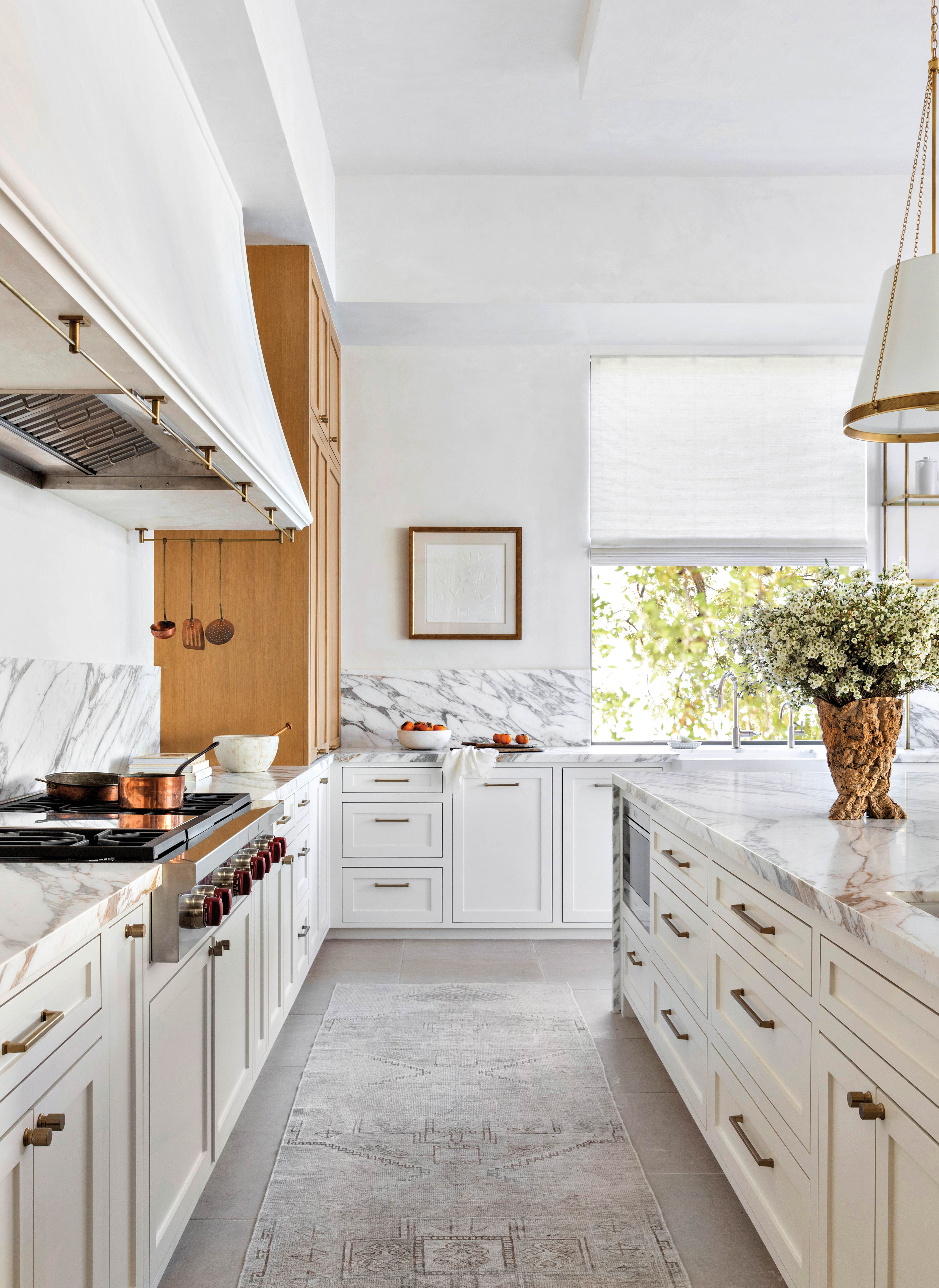 kitchen with a custom plaster hood and white rangetop 