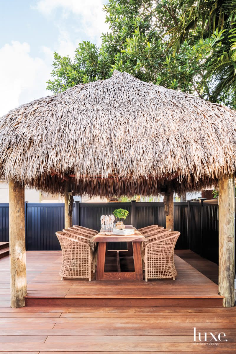 Tiki cabana shades wooden outdoor dining area