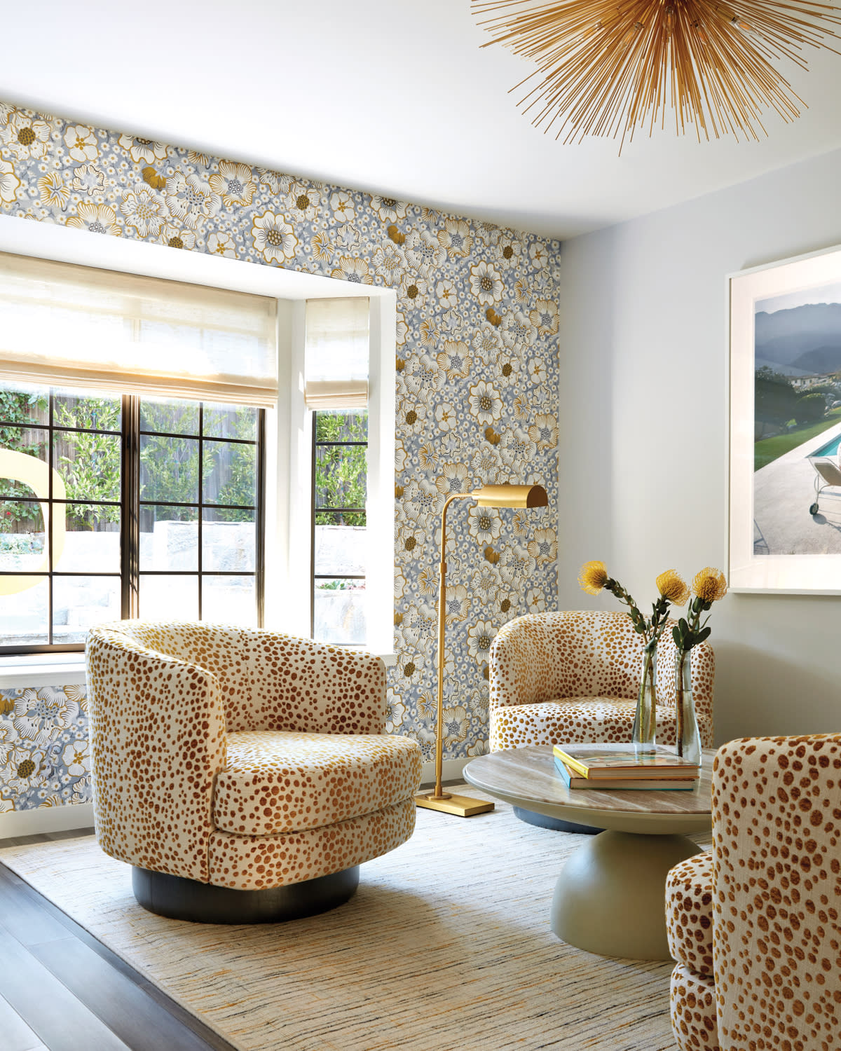 contemporary family room with a floral wallcovering and swivel chairs covered in a dotted fabric