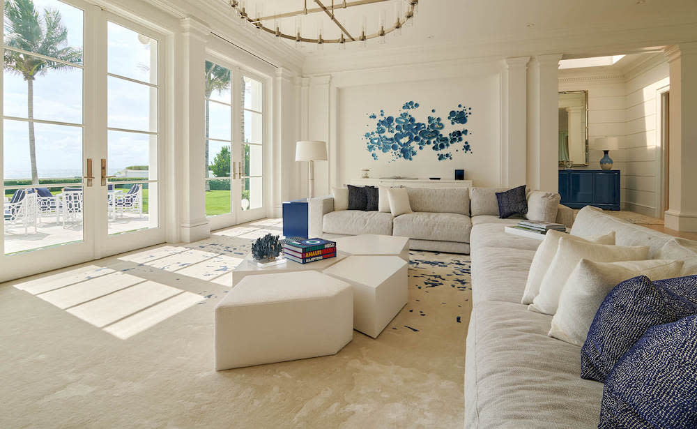 A modern living room showcasing elegant white furniture paired with vibrant blue accents, enhancing the overall aesthetic.