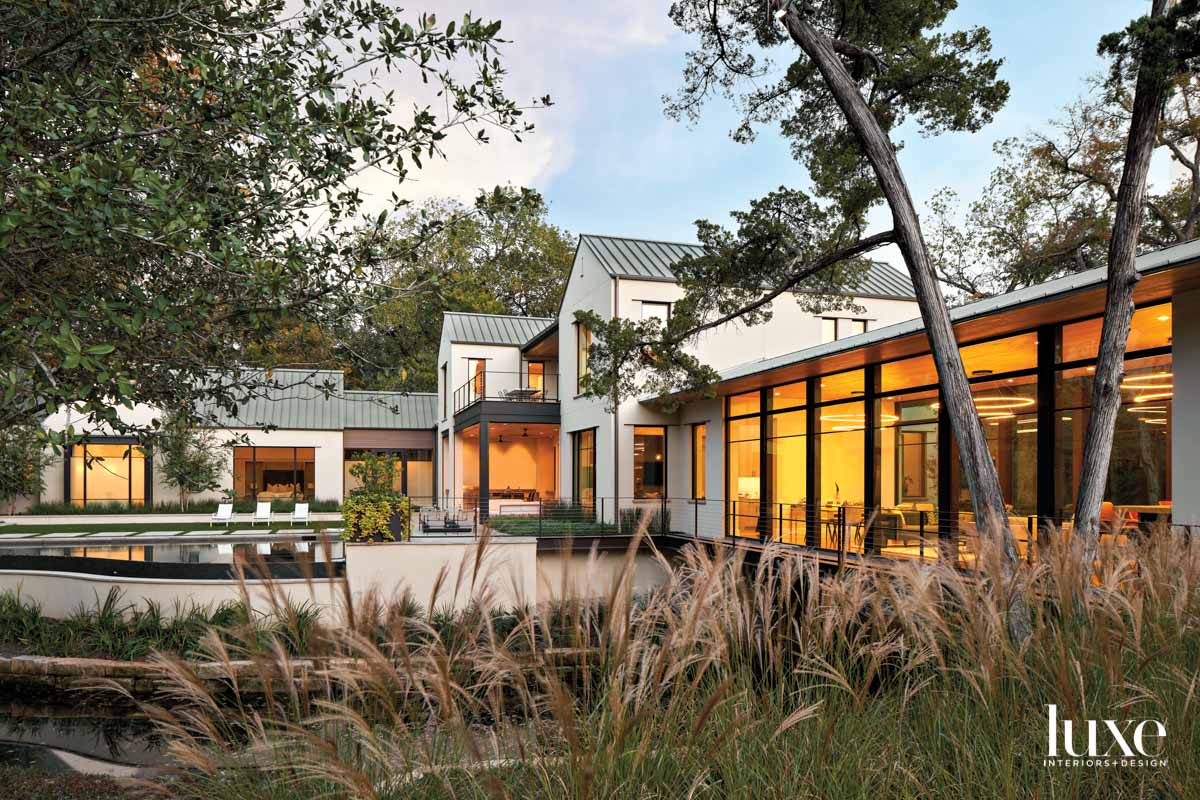 house exterior with light stucco walls and standing-seam metal roof