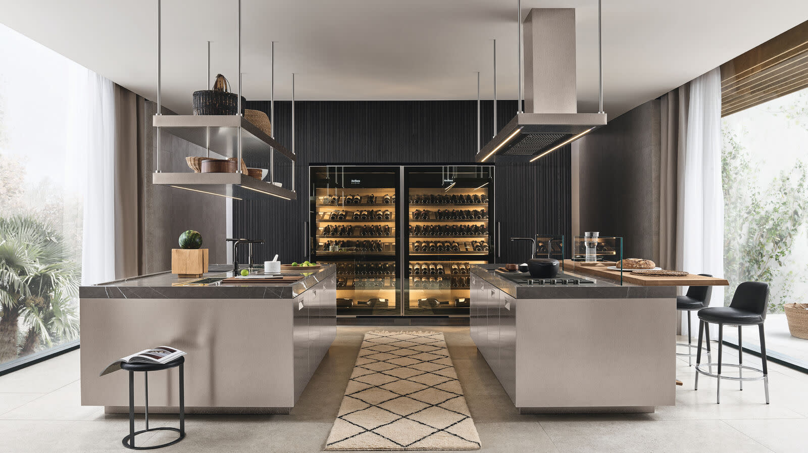 Sleek kitchen featuring wine fridge and bar in a spacious double island layout.