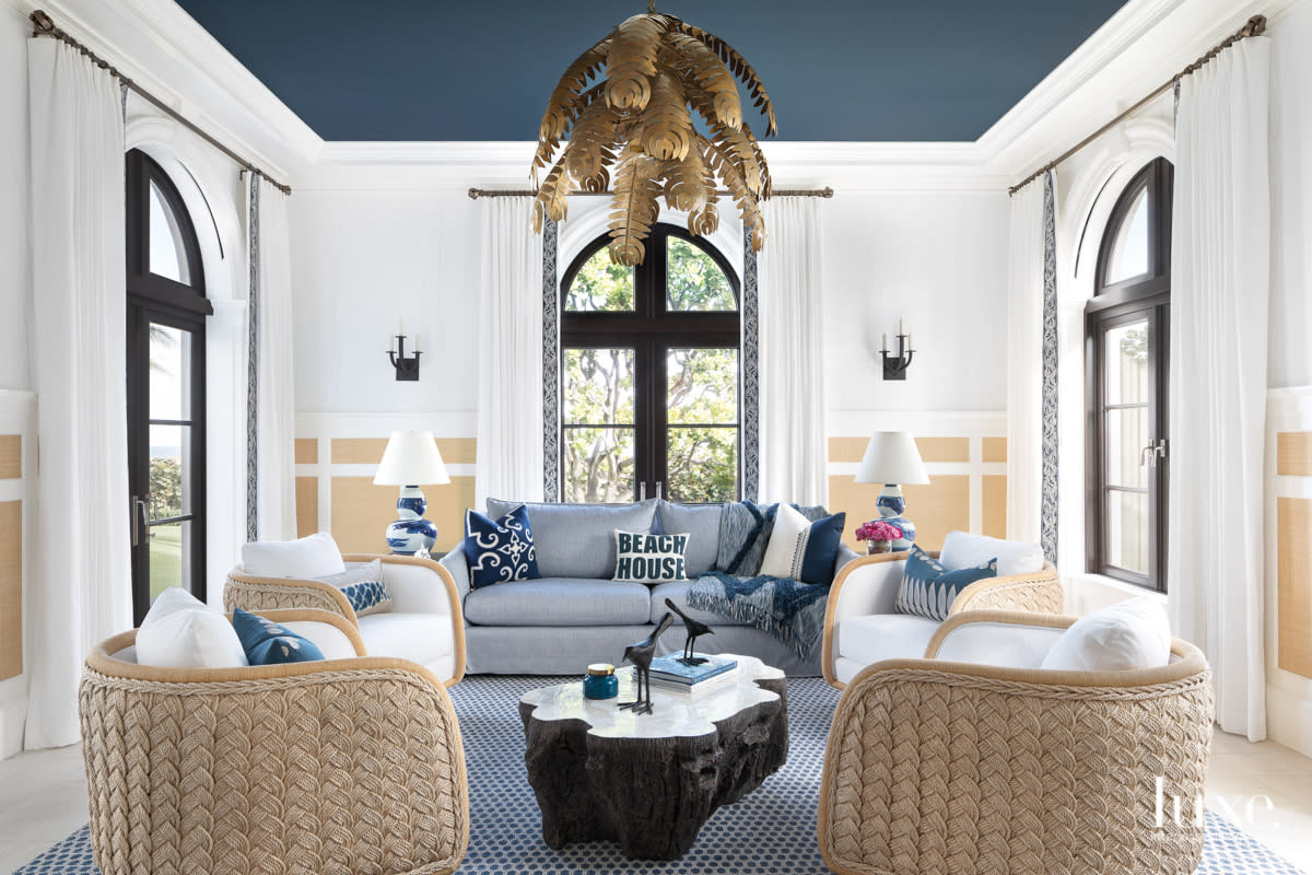cabana room with swivel lounge chairs and brass chandelier