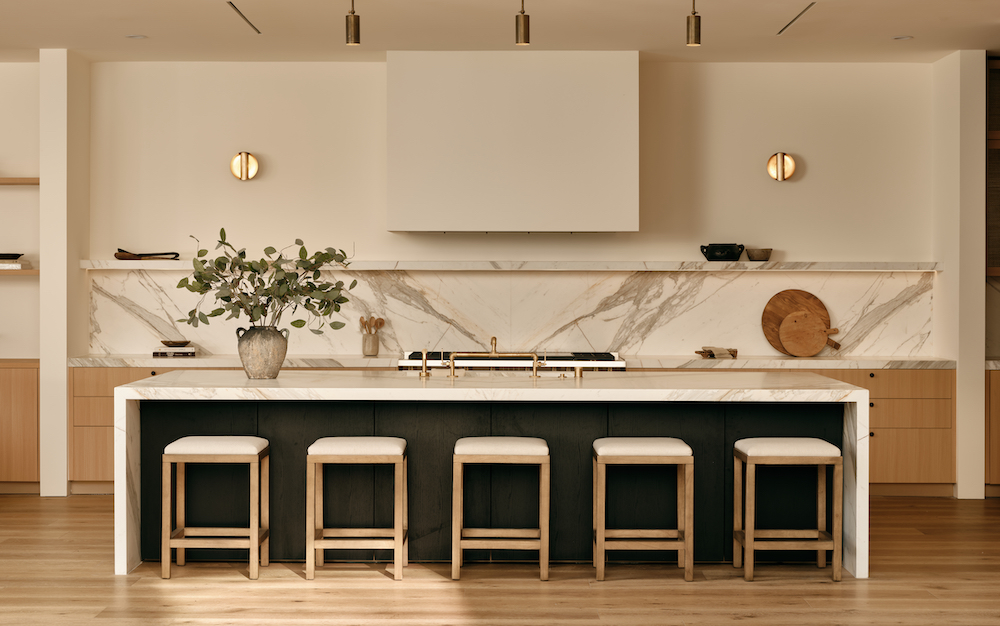 A modern kitchen featuring elegant marble countertops paired with warm wooden cabinets, creating a stylish and inviting atmosphere.