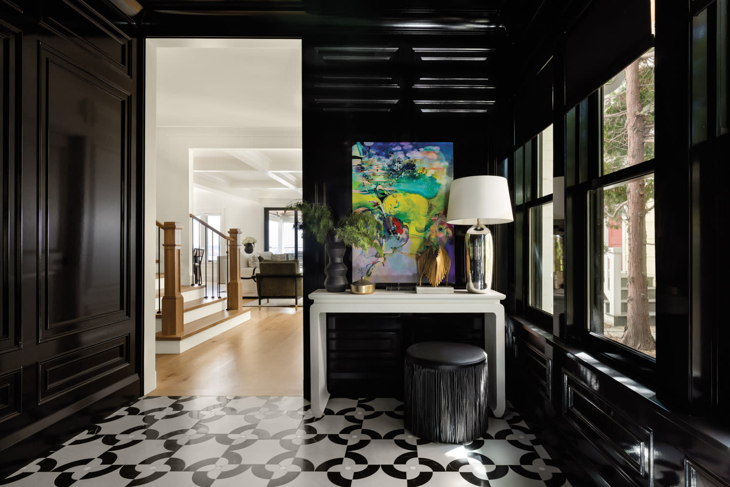 foyer with glossy black walls, marble mosaic and abstract artwork by Kristi Street