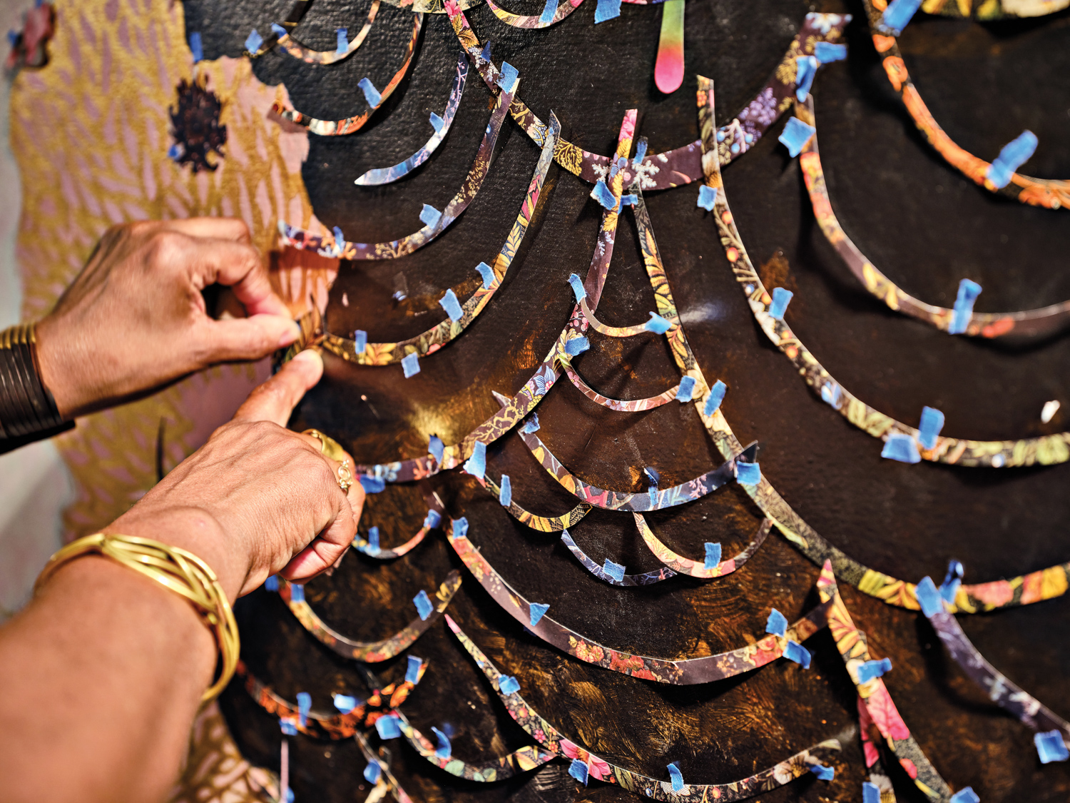 close-up of vickie pierre's hands assembling a collage