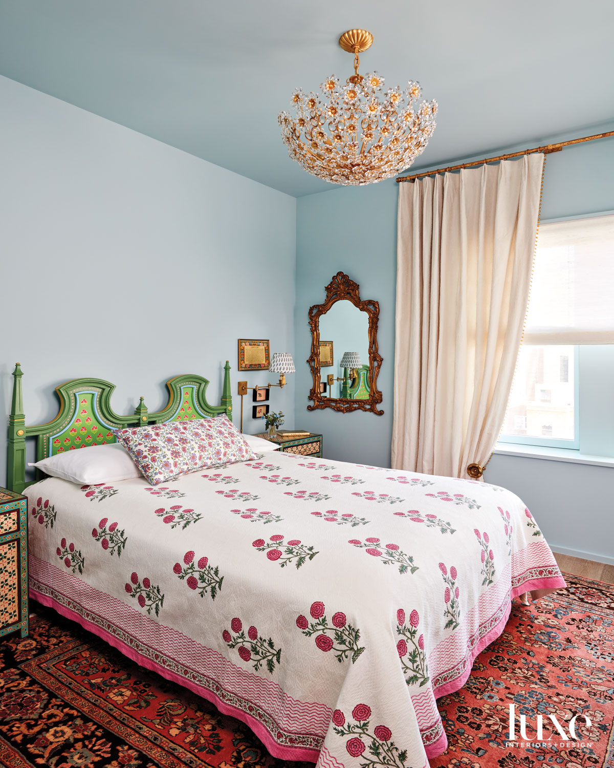 blue bedroom with persian rug and vintage headboard