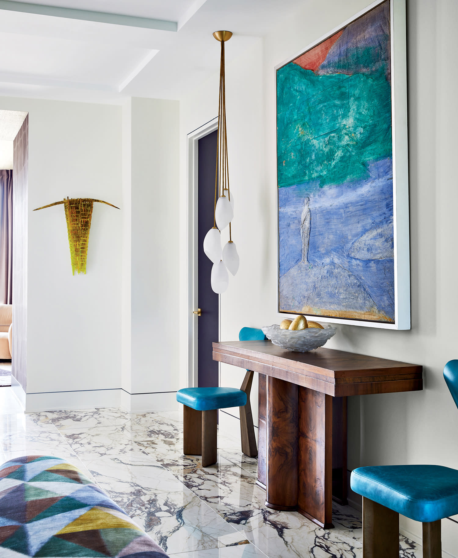 Calacatta Viola marble flooring lines the entryway of a bold, modern penthouse