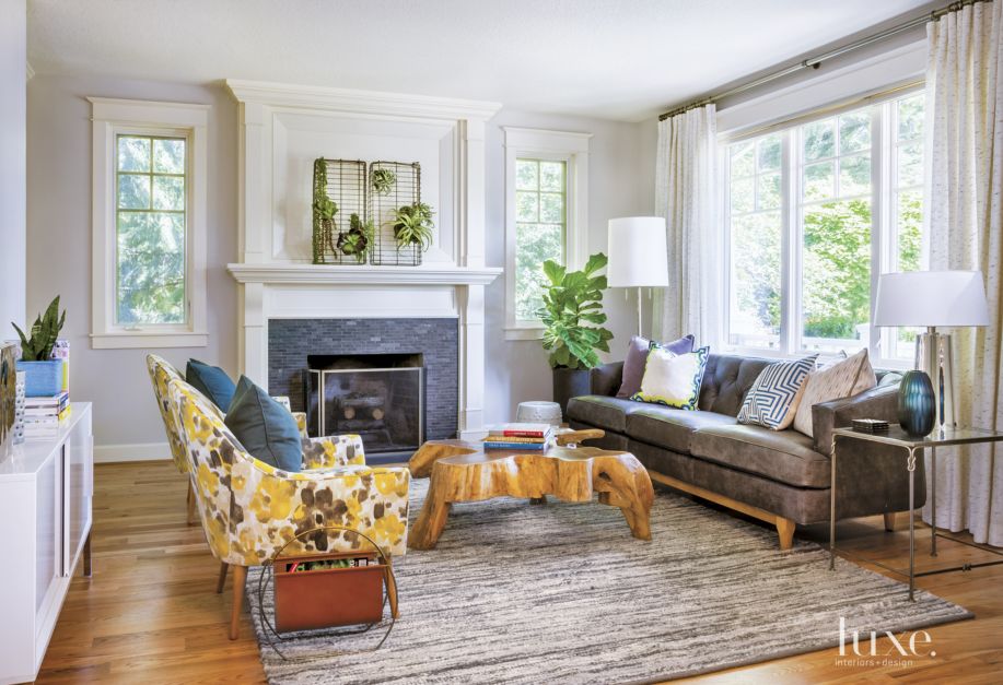 light-filled seating area with floral themed armchairs and rug