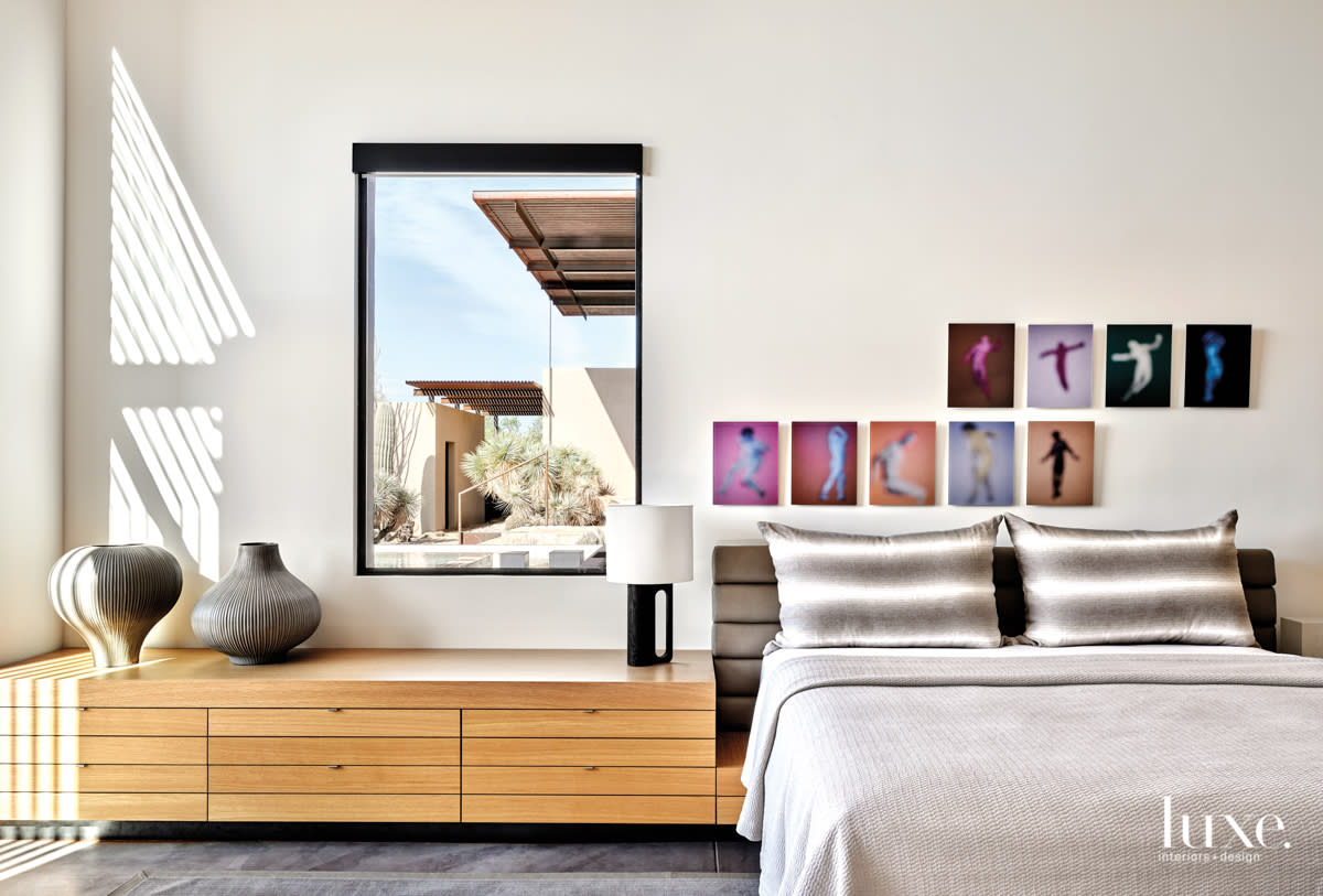 The master bedroom with artwork by Bill Armstrong above the custom bed.