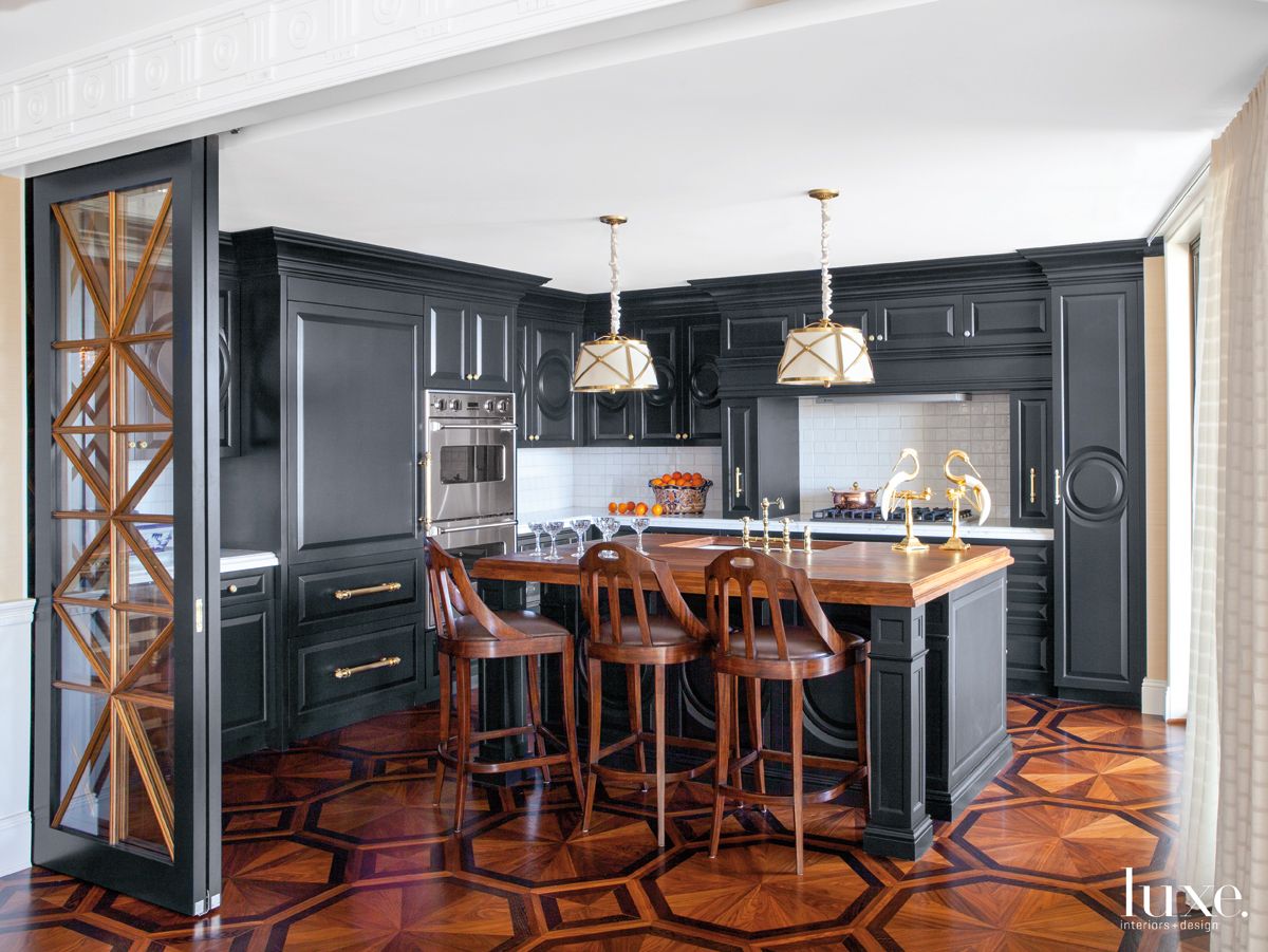 dining room with black cabinets, hanging white lights and brown chairs