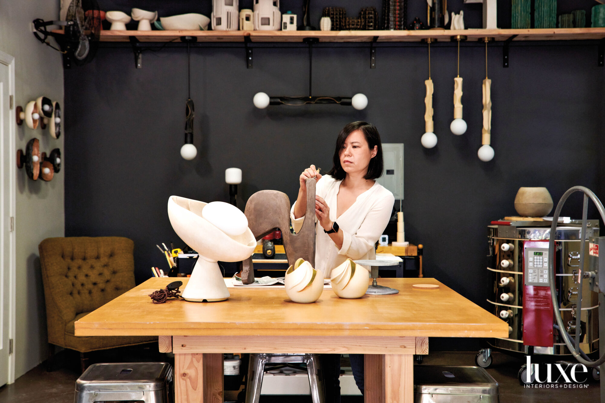 Jenny Poston in studio with lighting collection on a table